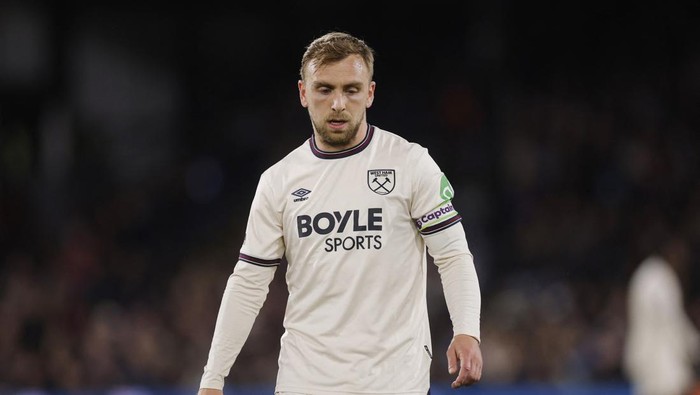 Male West Ham United footballer in a white away kit with Boyle Sports sponsor and captain's armband on his left arm.