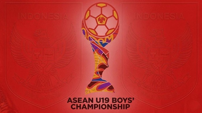 Banner for the ASEAN U19 Boys' Championship featuring a stylized trophy with a ball on top on a red background, with faded Indonesian crests on both sides.
