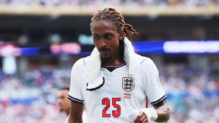 England national team footballer wearing white jersey with number 25, towel draped around neck after a match.
