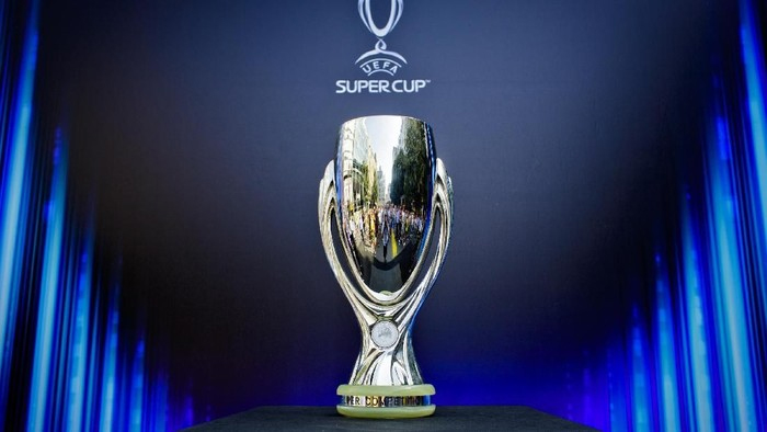 UEFA Super Cup trophy on a black pedestal against a dark blue backdrop with blue lighting.