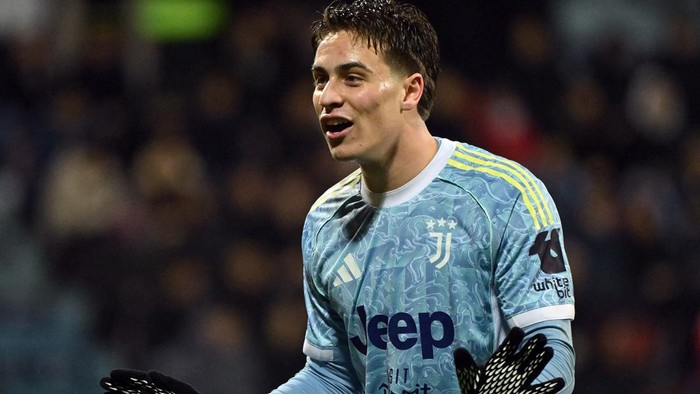 Juventus goalkeeper wearing a light-blue kit and gloves, celebrating on the field during a match.