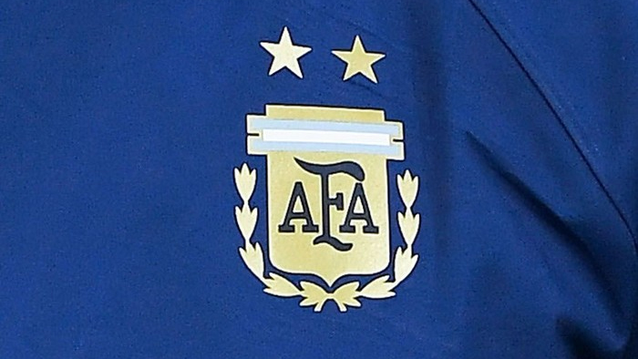 Blue fabric featuring the Argentine Football Association (AFA) crest with two gold stars above it.