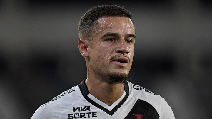 Close-up of a male soccer player in a white jersey looking to the right.